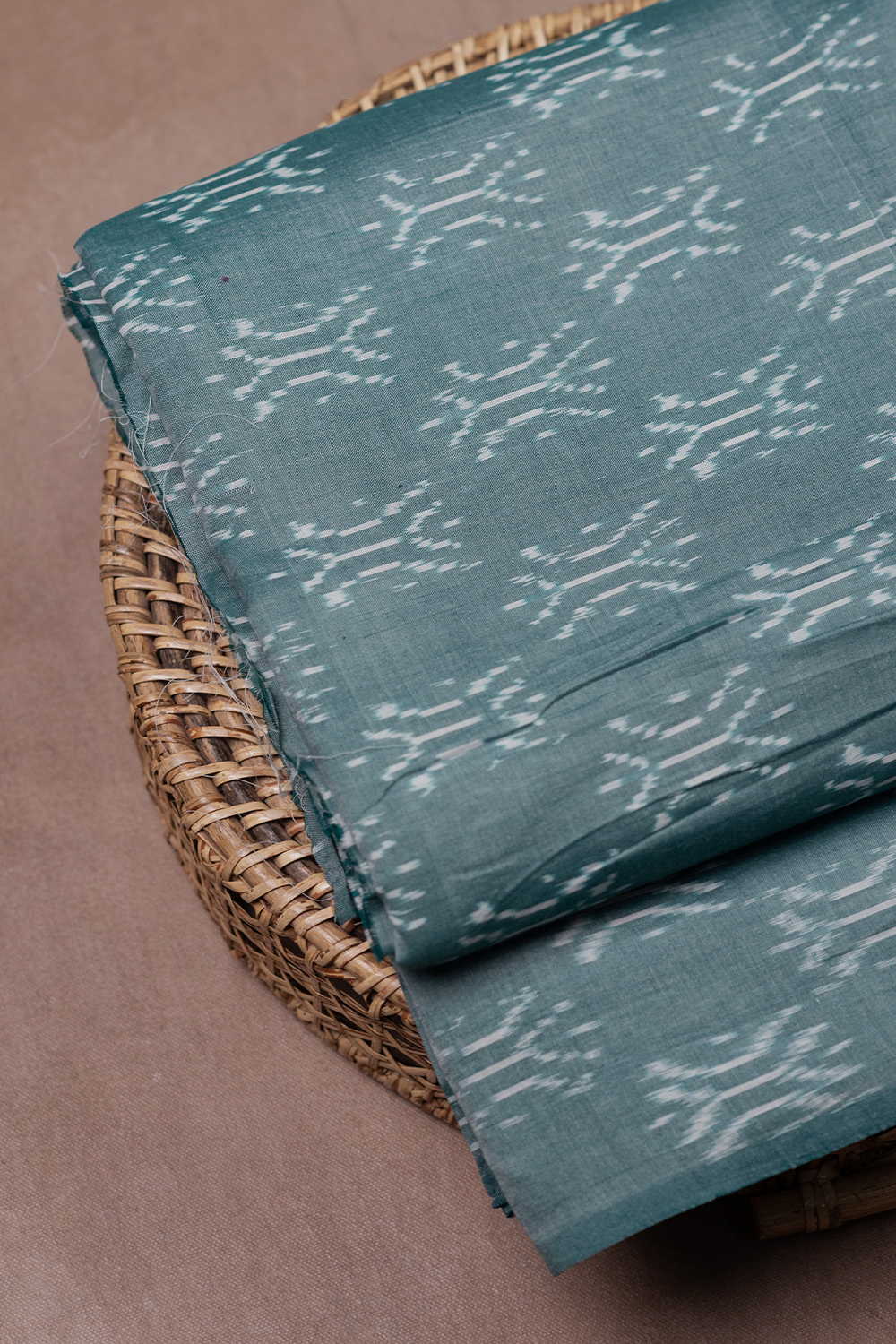 Buttas on Green Mercerized Ikat Cotton Fabric